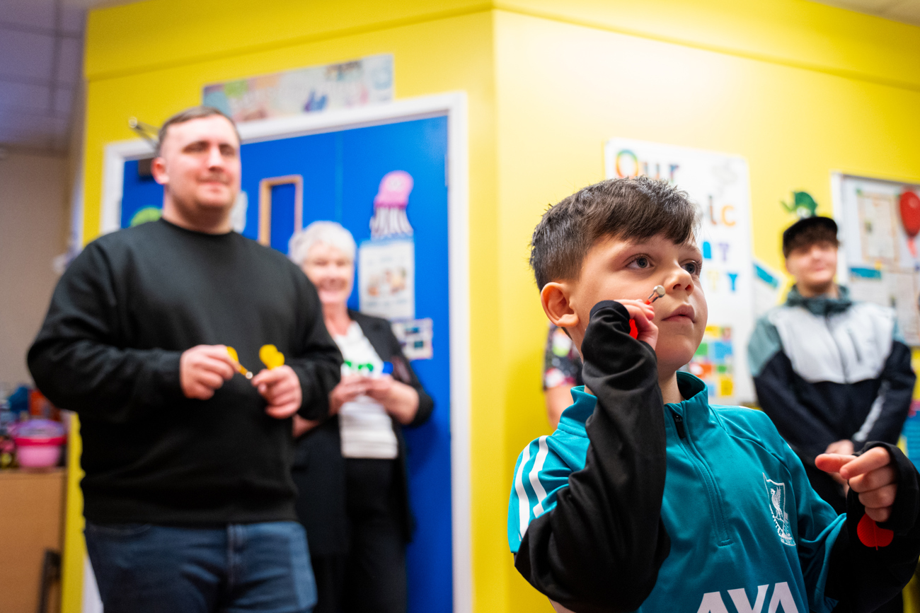 Luke Littler playing darts with Ezra, aged 7 